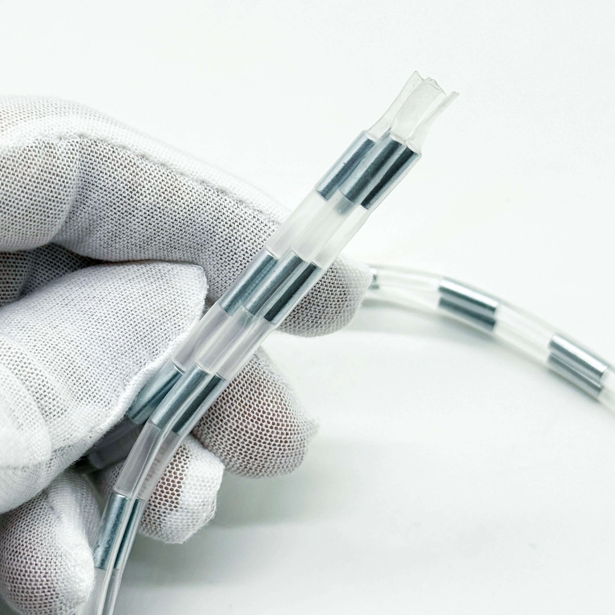 Flexible tube-encased NdFeB magnetic zipper strip HJ-089 held in gloved hand