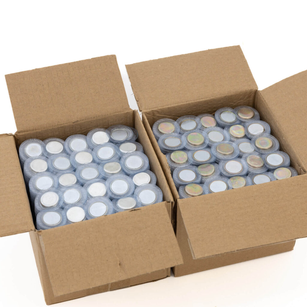 Bulk trays and clear bags of hidden sew-in magnetic buttons prepared for MOQ planning and factory packing